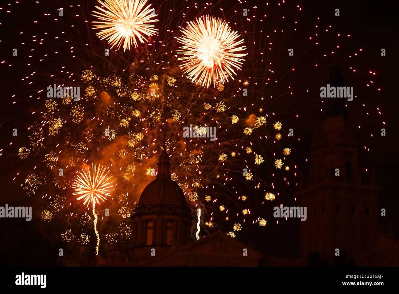 fireworks in a dark sky showing the silhouette of a domed building Stock Photo