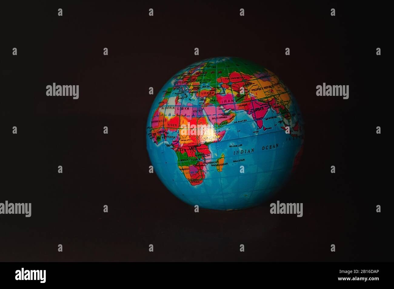 Multicolored globe isolated on a dark background. Stock Photo