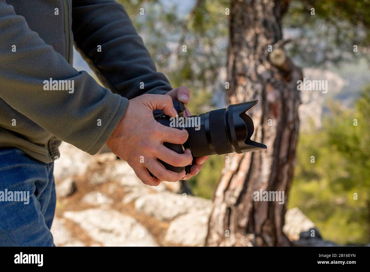 The photographer who takes pictures by hand fixing the camera Stock ...