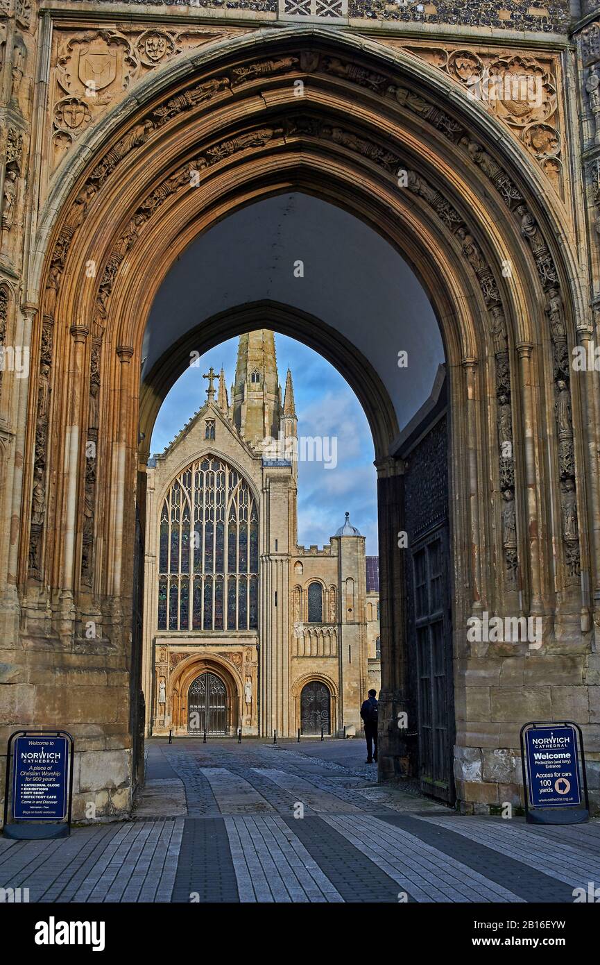 Stone archway leading through to Norwich Cathedral, the cathedral is dedicated to the Holy and Undivided Trinity. Stock Photo
