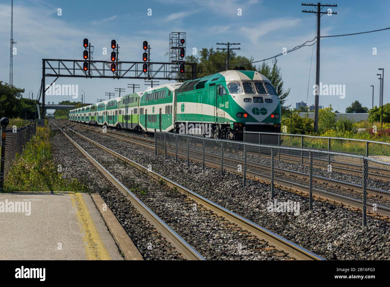 Scarborough, Ontario, Canada, Oct 2017 - Go train passing under a railroad signal bridge at Scarborough Stock Photo