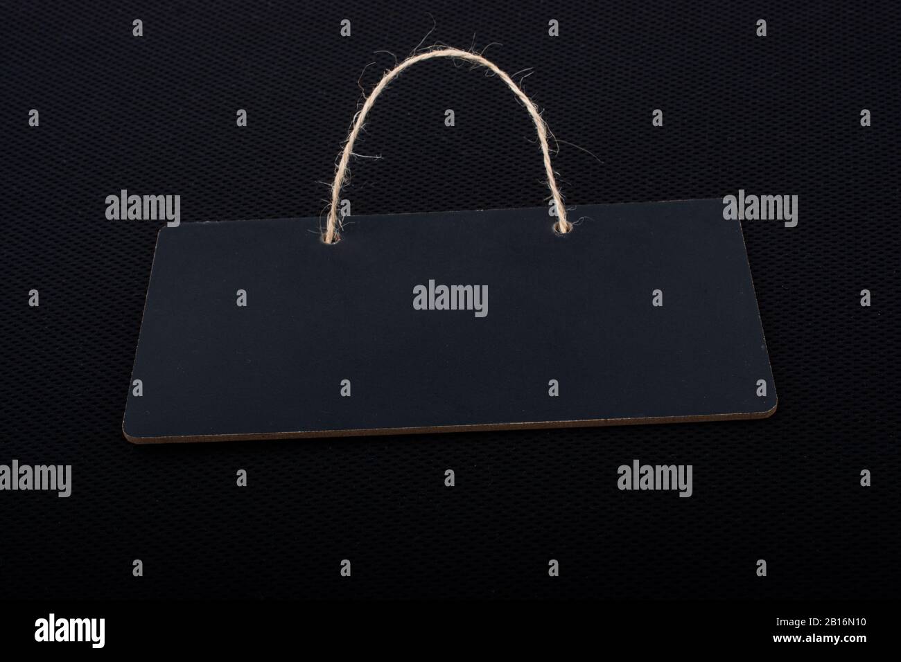 Rectangular shaped black notice board on black background Stock Photo