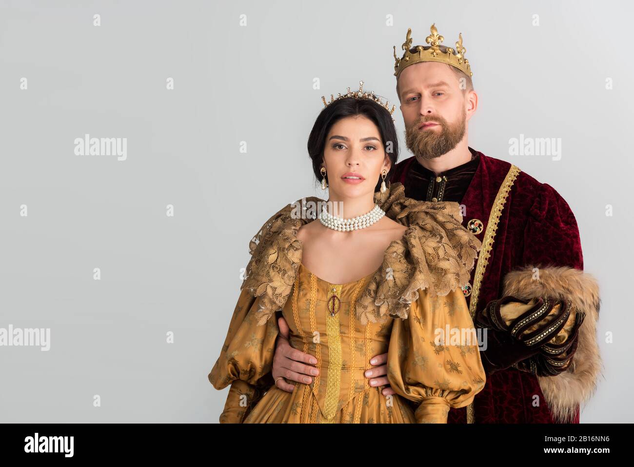 king with crown hugging attractive queen isolated on grey Stock Photo -  Alamy
