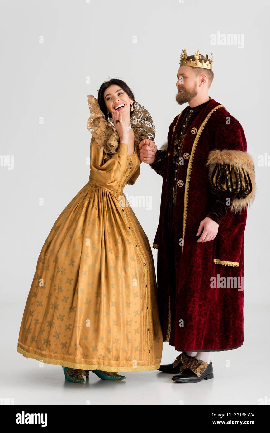 smiling queen and king with crowns holding hands on grey background Stock  Photo - Alamy