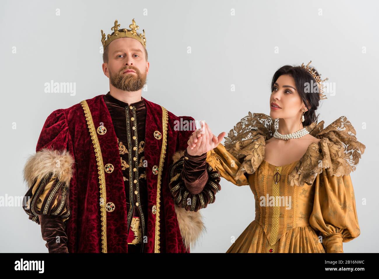 queen and king with crowns holding hands isolated on grey Stock Photo -  Alamy