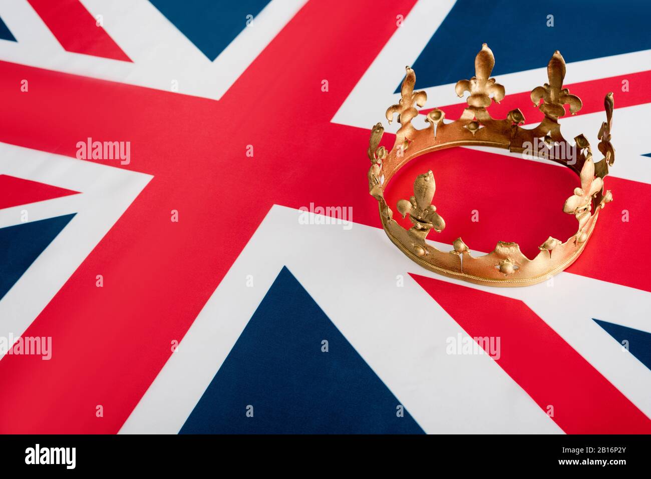 high angle view of golden crown on british flag Stock Photo - Alamy