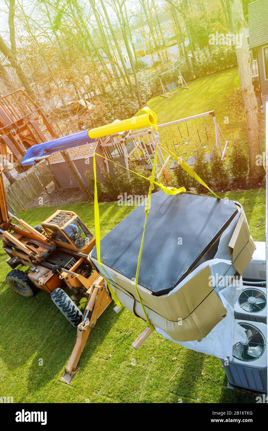 Forklift on a preparing to raise construction with risen telescopic boom in jacuzzi. Stock Photo