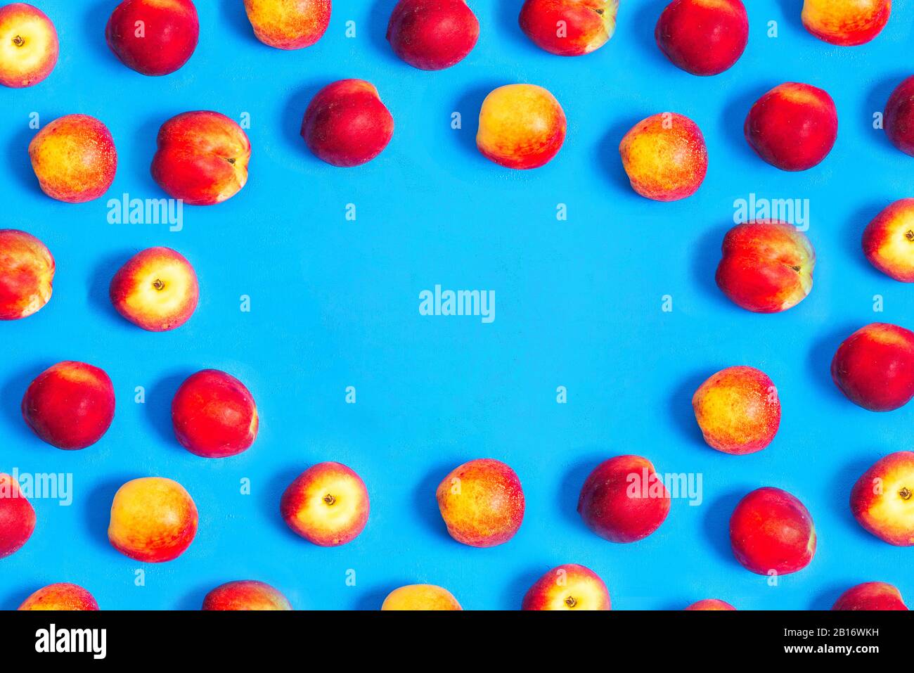 Peaches and nectarines background, top view. Fresh peaches on a blue background with copy space Stock Photo