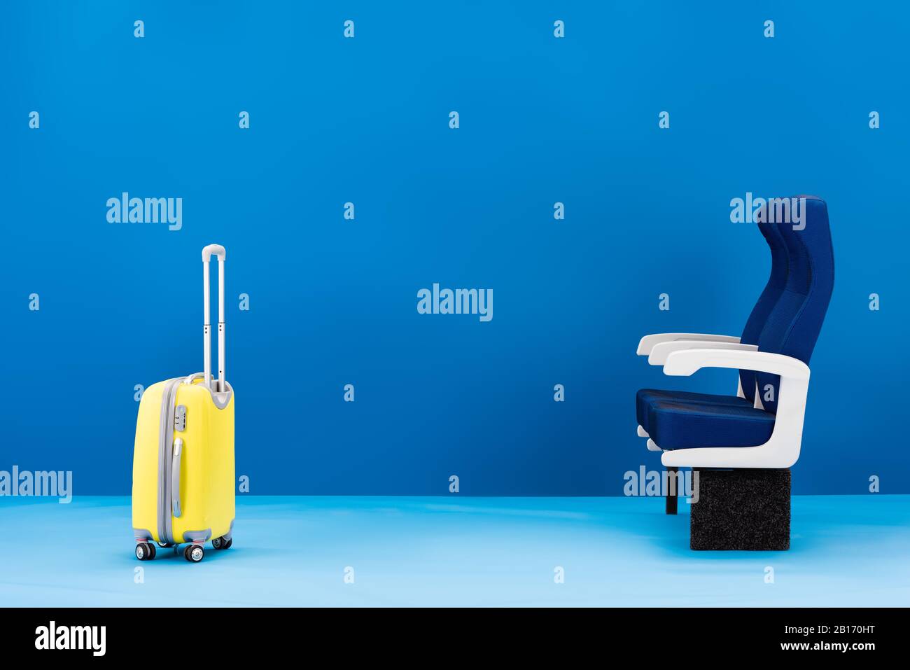 yellow travel bag and seats on blue background Stock Photo Alamy