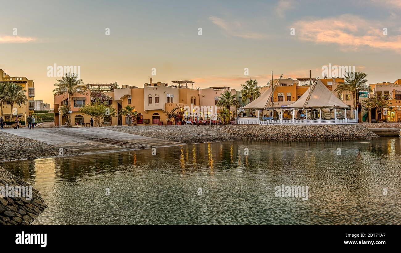the harbour promenade from the seaside in the sunset with orange sky at the New Marina, el Gouna, Egypt, January 17, 2020 Stock Photo
