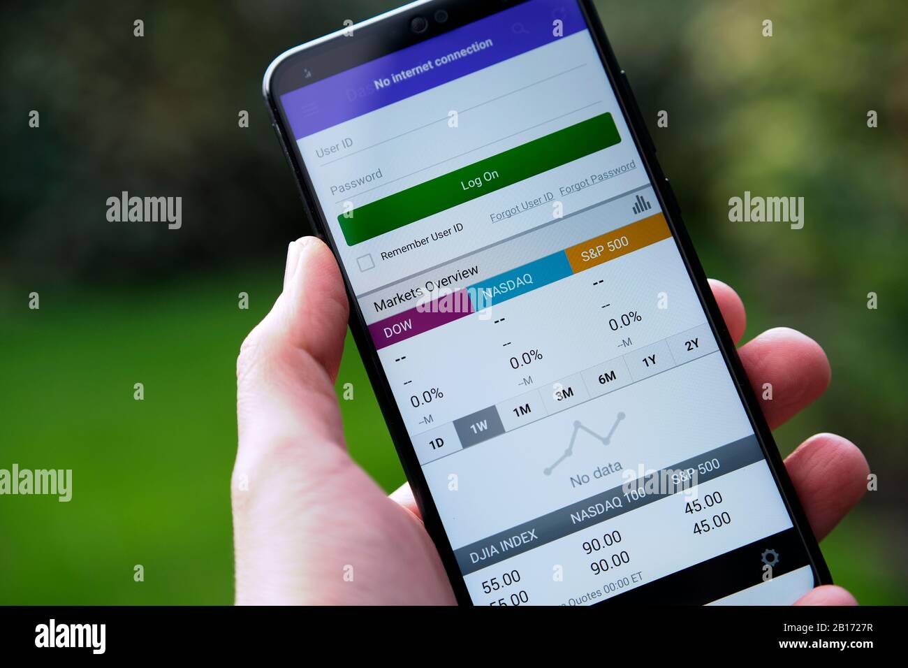 E-TRADE app login screen seen on the smartphone hold in a hand. Stock Photo