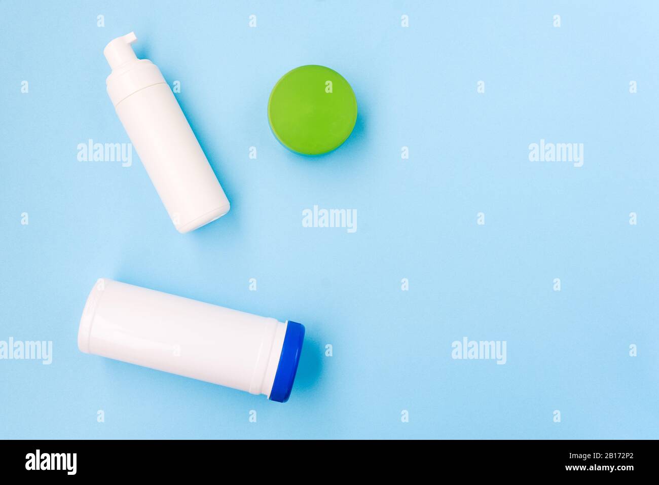 Cosmetic products on a blue background. Face foam, cream and a napkin can. Body and skin care. Beauty salon, spa concept Stock Photo