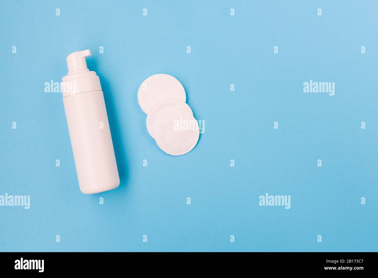 Foam for face and cotton pads. Face and body care. Cosmetic products on a blue background. Female and male beauty Stock Photo