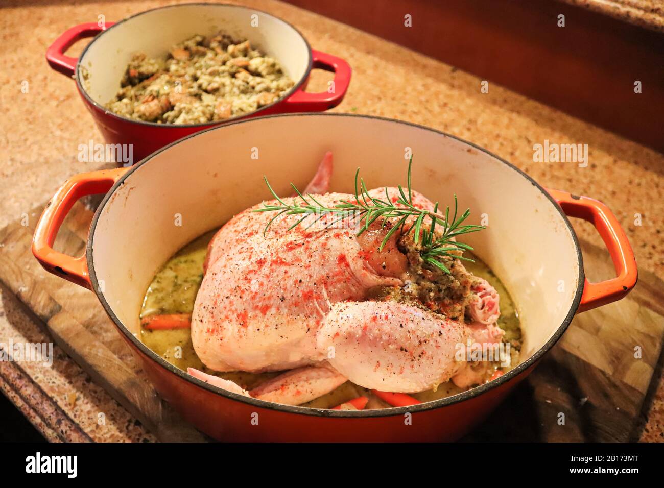 Top view of a raw chicken with stuffing in a pot Stock Photo