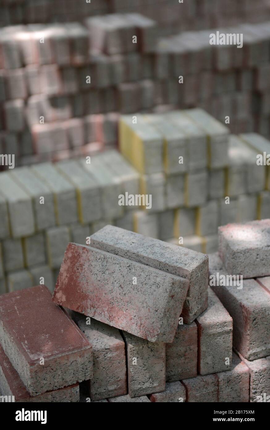 Stacks of paving bricks ready for laying on a path in Wangjing district, Beijing, China Stock Photo