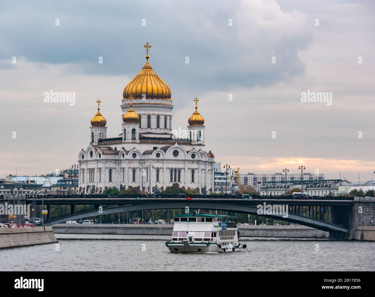 River boat on Moskva River at sunset and St Saviour's Cathedral, Moscow, Russian Federation Stock Photo