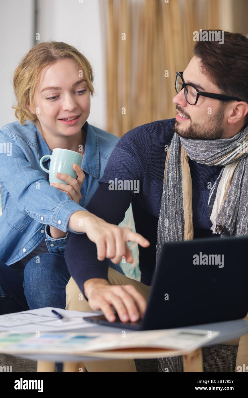 cheerful good looking couple on the sofa Stock Photo