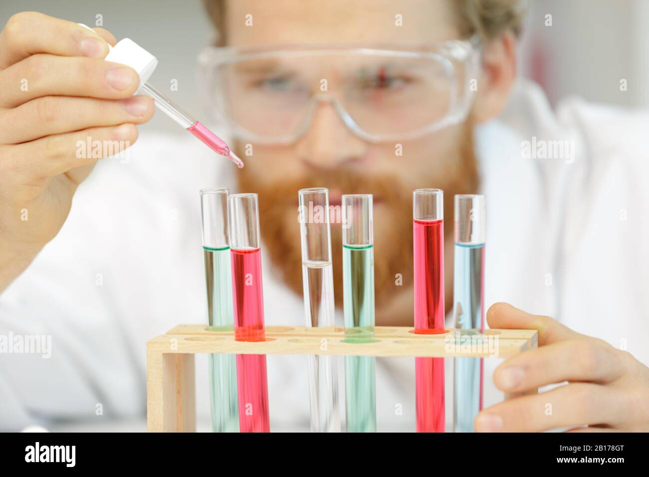 drop red liquid over glass test tubes Stock Photo Alamy