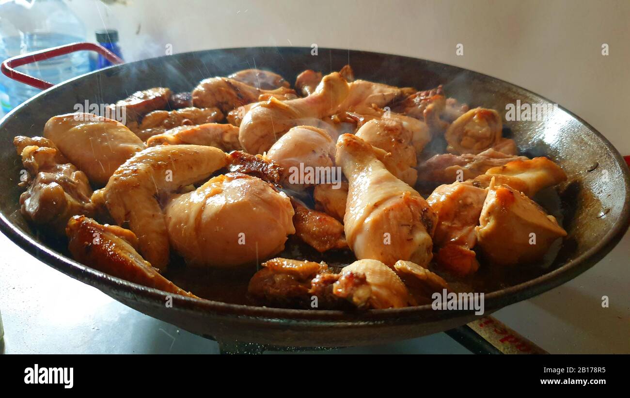 chicken legs are fried in a pan, Spain, Balearic Islands, Majorca Stock Photo