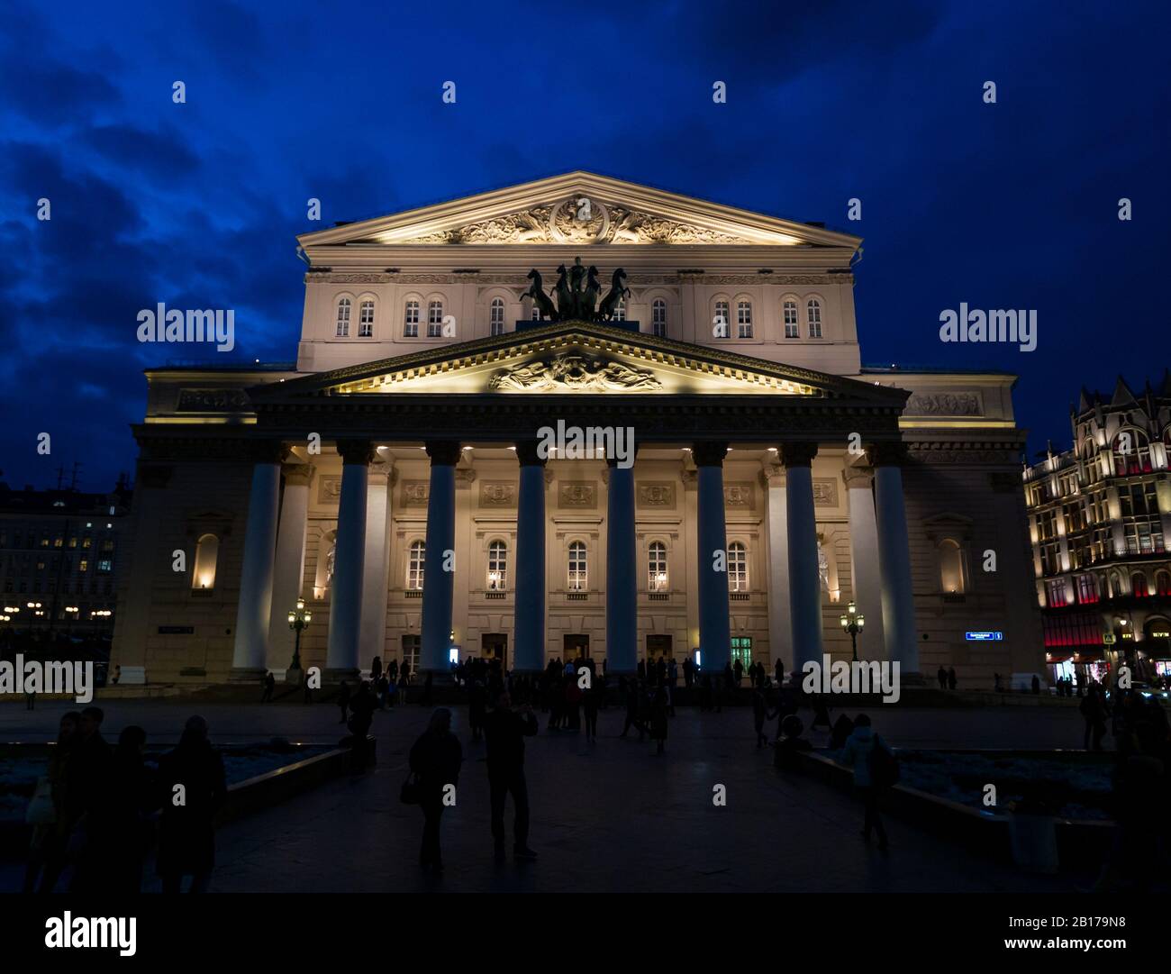 Bolshoi Theatre lit up at night with people in the square, Theatre Square, Moscow, Russian Federation Stock Photo