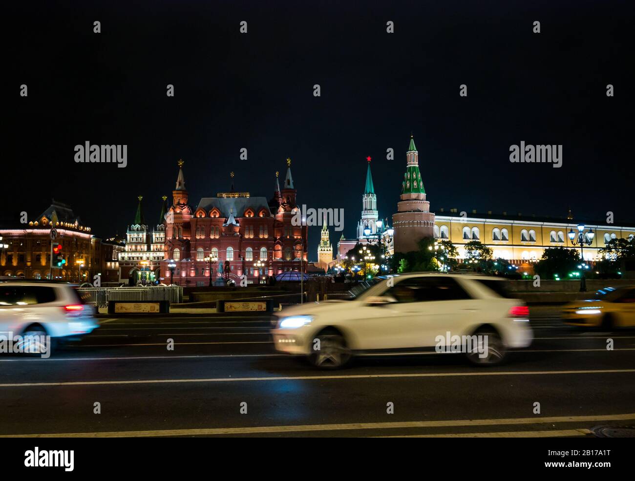 Traffic at night, Manezhnaya Square with Kremlin Towers & State Museum,  Moscow, Russian Federation Stock Photo