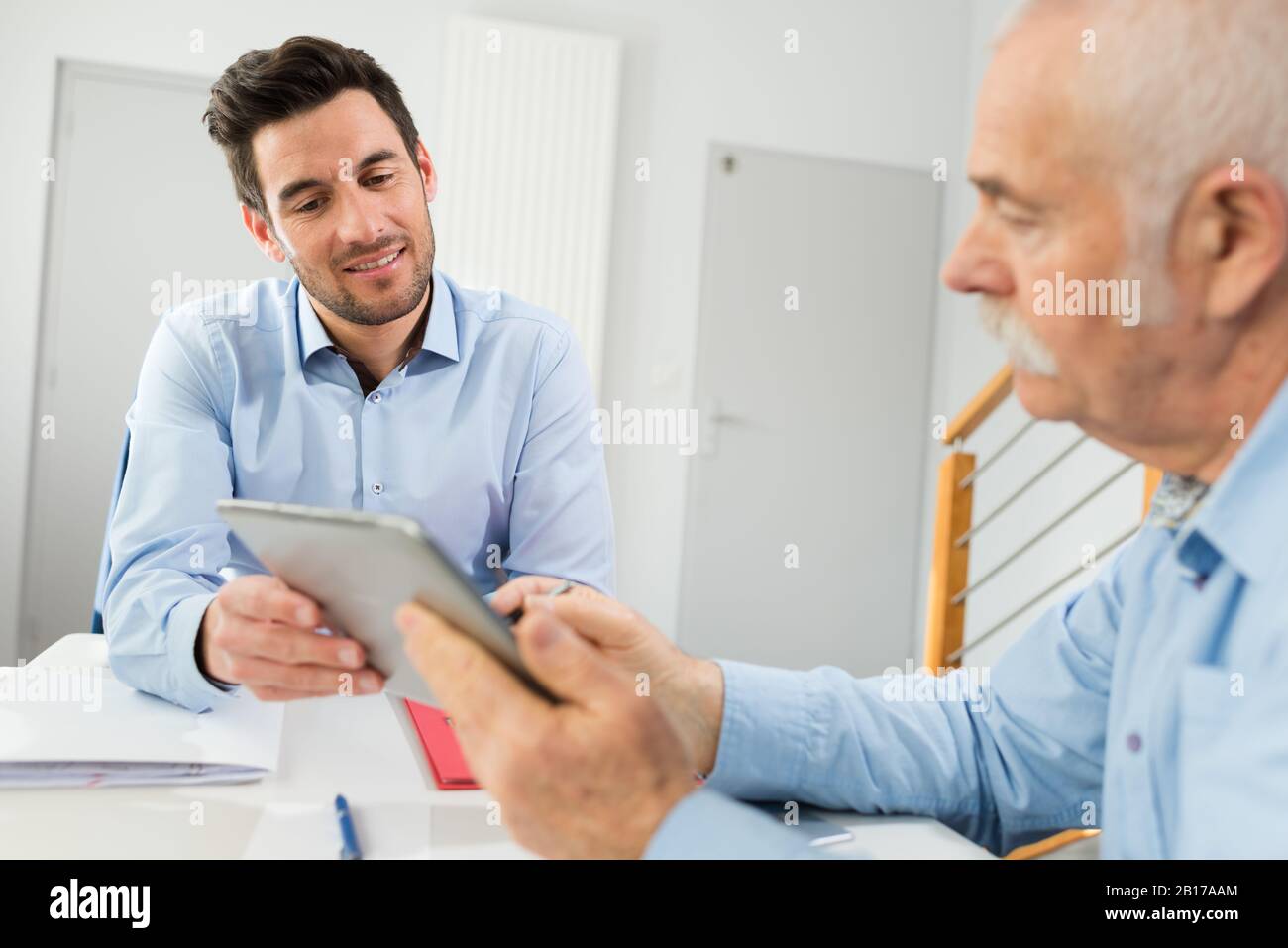 professional adviser showing important information to client Stock Photo
