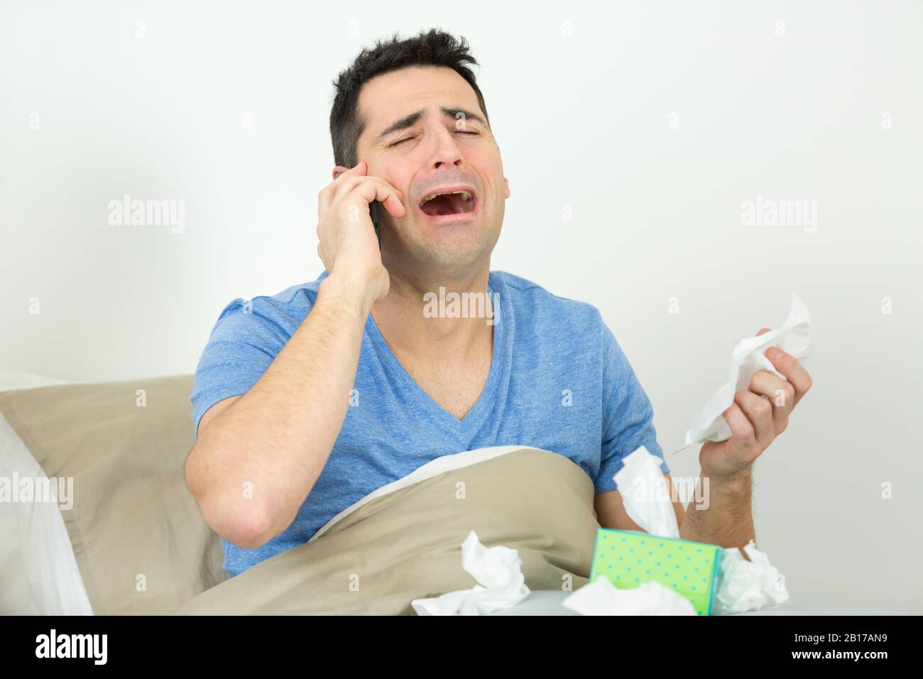 sad man sobbing at home Stock Photo