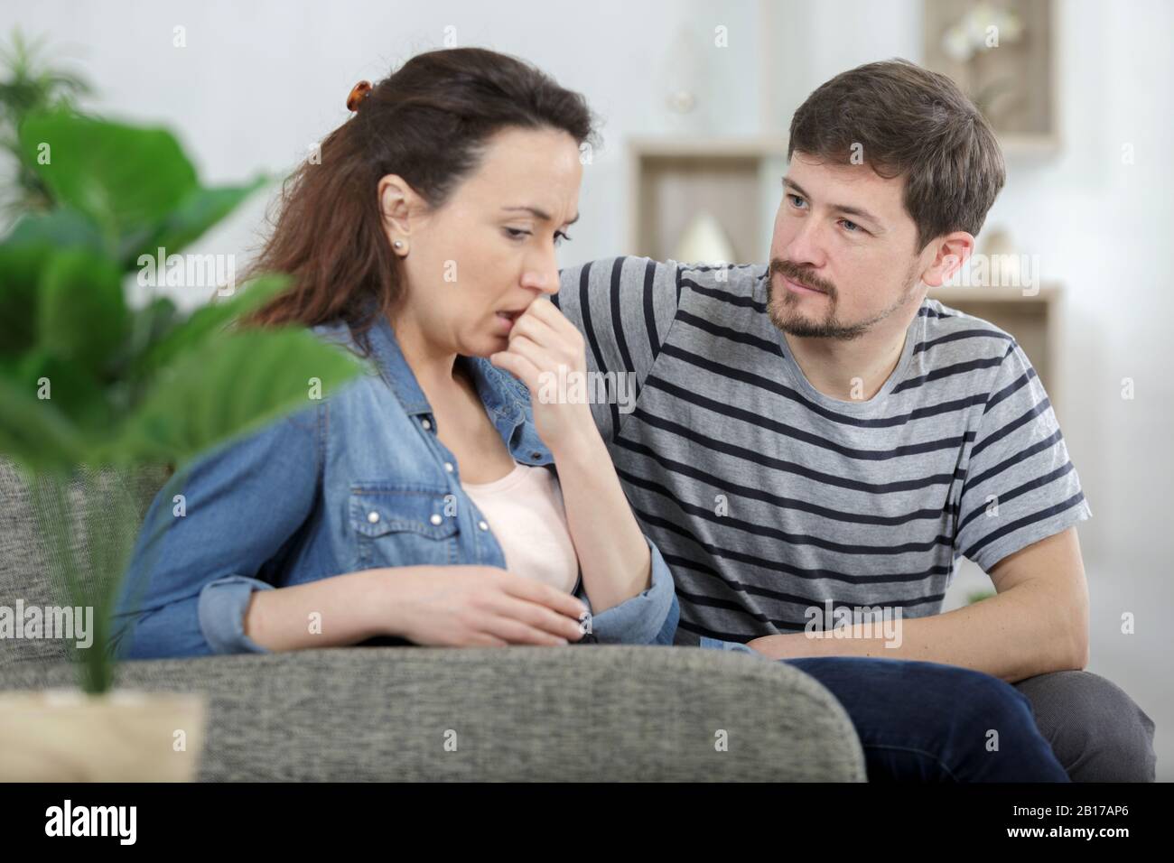 sad female is depressing while husband is supporting her Stock Photo