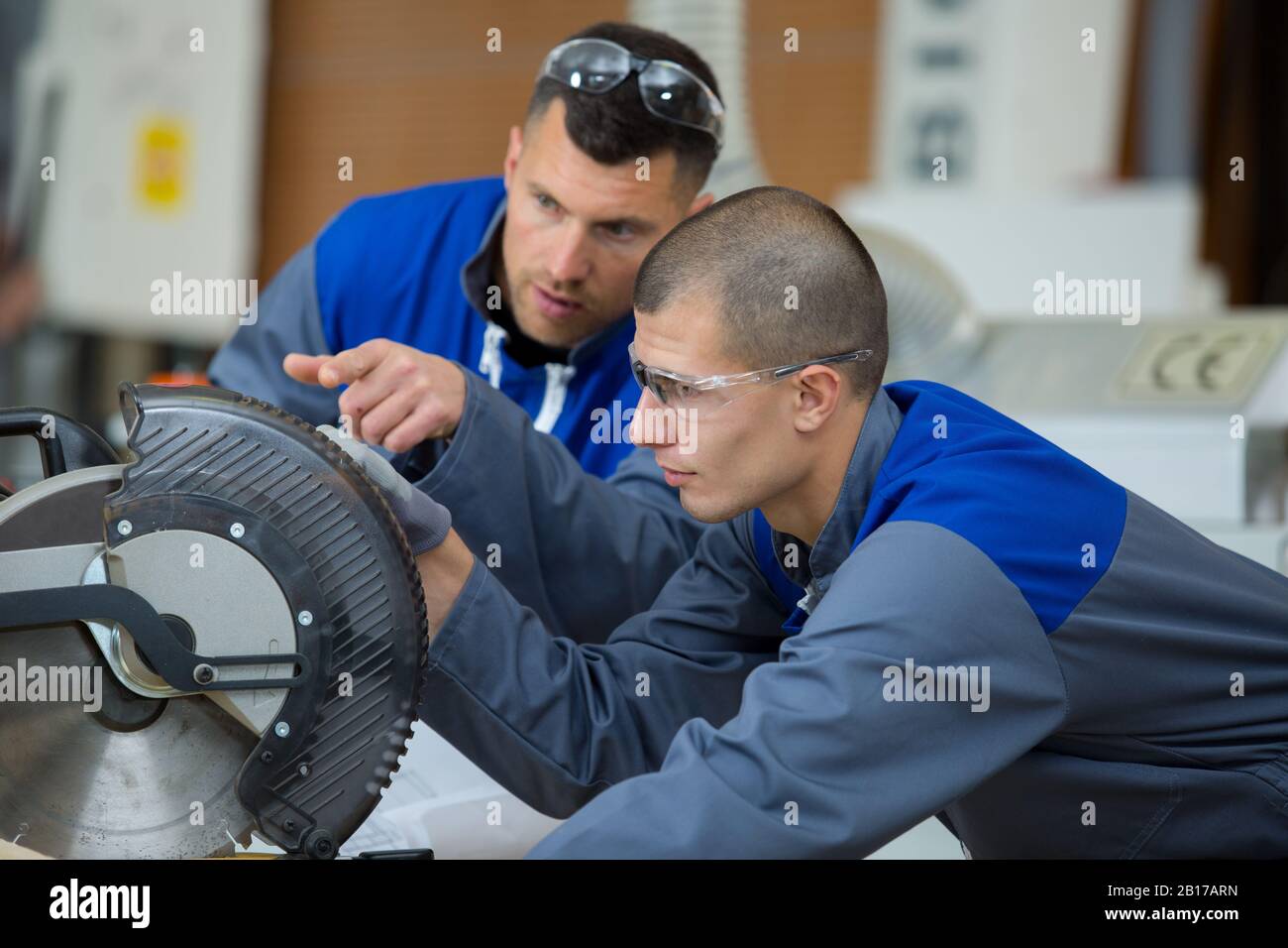 student in carpentry class using circular saw Stock Photo