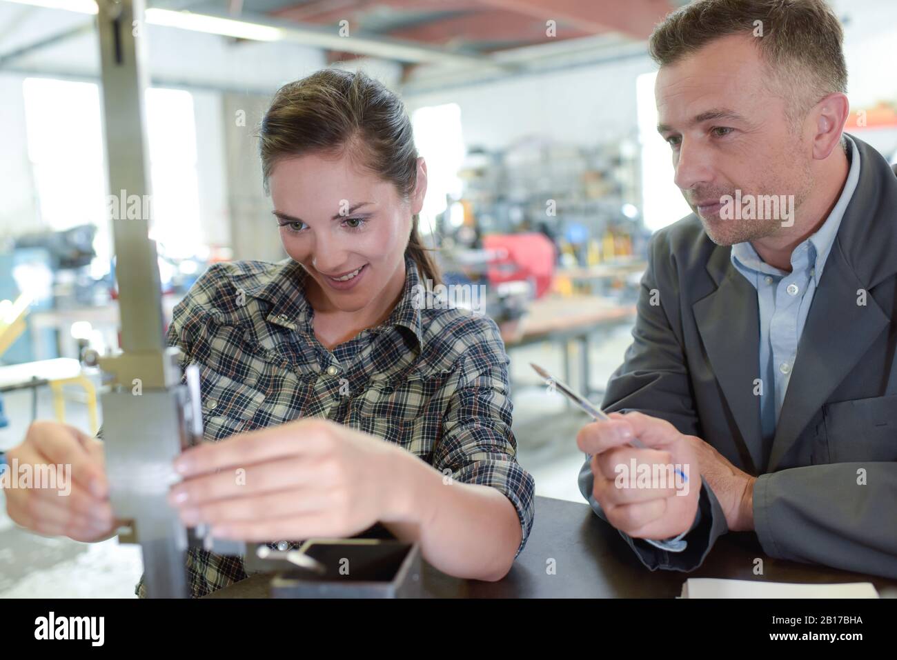female engineer quality controlling components in factory Stock Photo