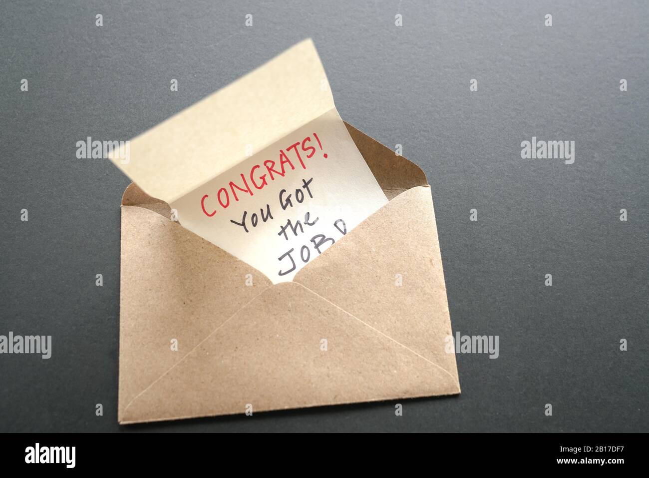 Congrats you got the job, a message inside a brown envelope. New job or employment concept. Stock Photo