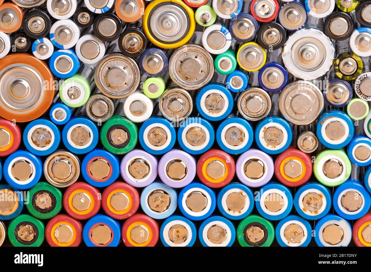 Close up of colorful spent discharged batteries of different sizes and formats. Used rechargeable Nickel Metal Hydride (Ni-MH), Nickel-Cadmium(Ni-Cd) Stock Photo