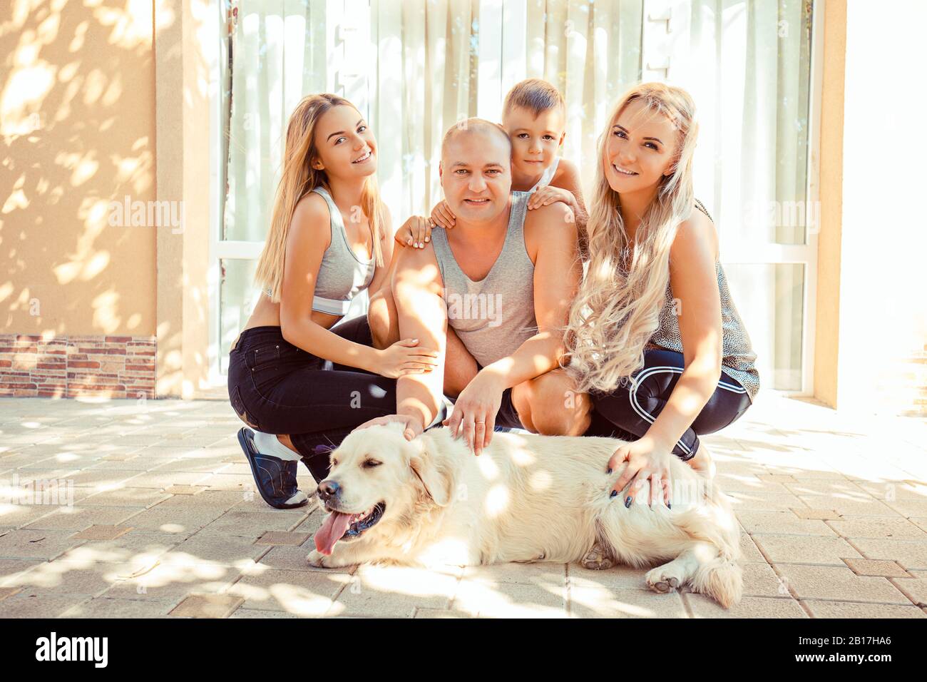 Happy family concept. Daughter, son, mom and dad, dog in front of the ...