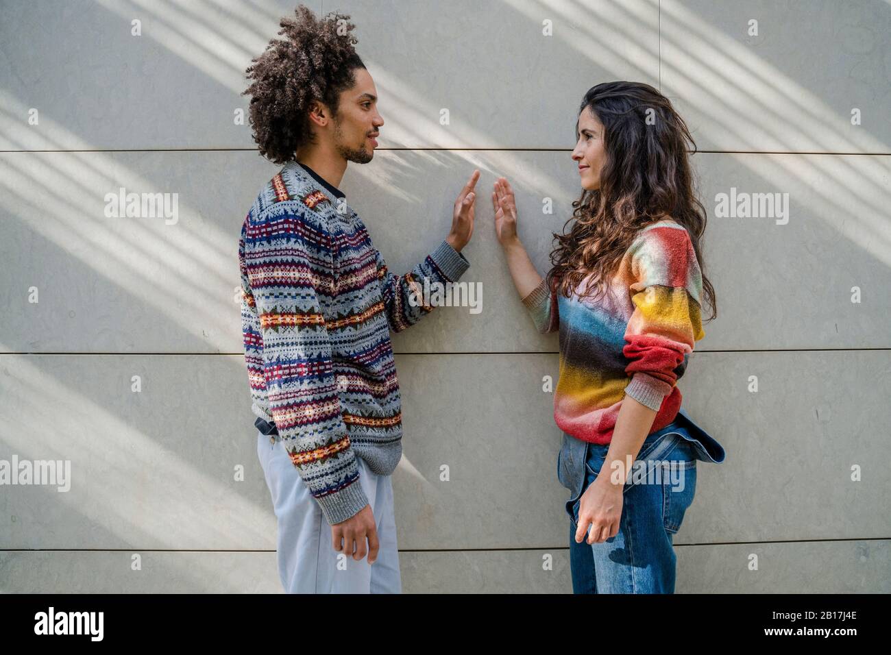Couple of dancers face to face in front of a wall Stock Photo