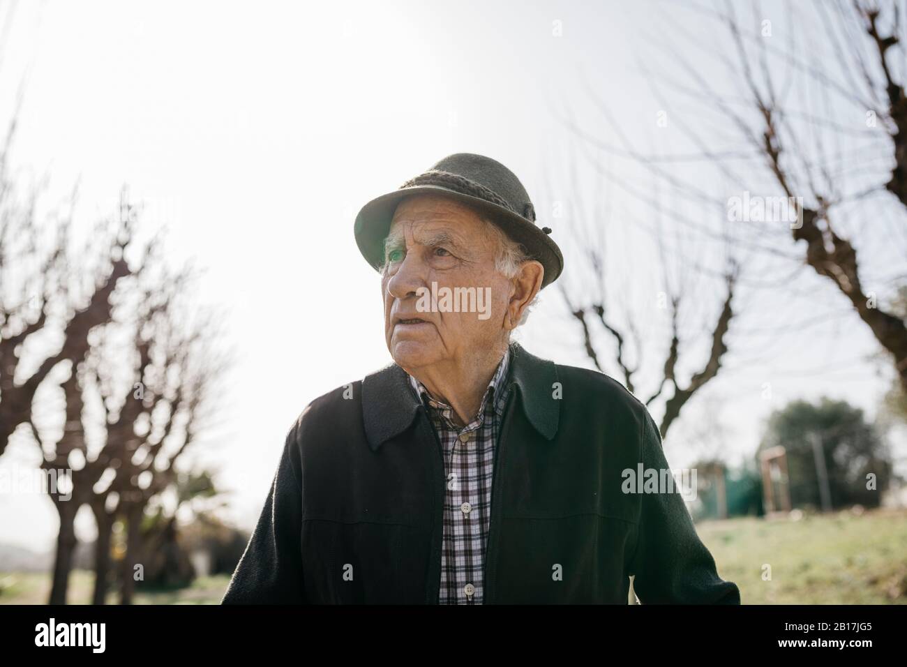 Old man walking in winter park, portrait Stock Photo