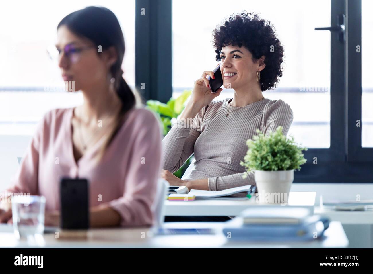 Businesswoman phoning at the office Stock Photo