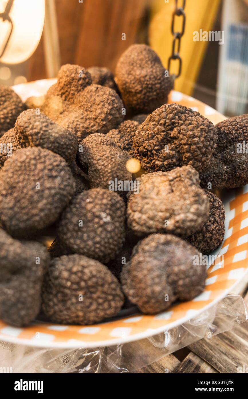 Italy, Heap of black truffles (Tuber melanosporum) on weight scale of local market Stock Photo