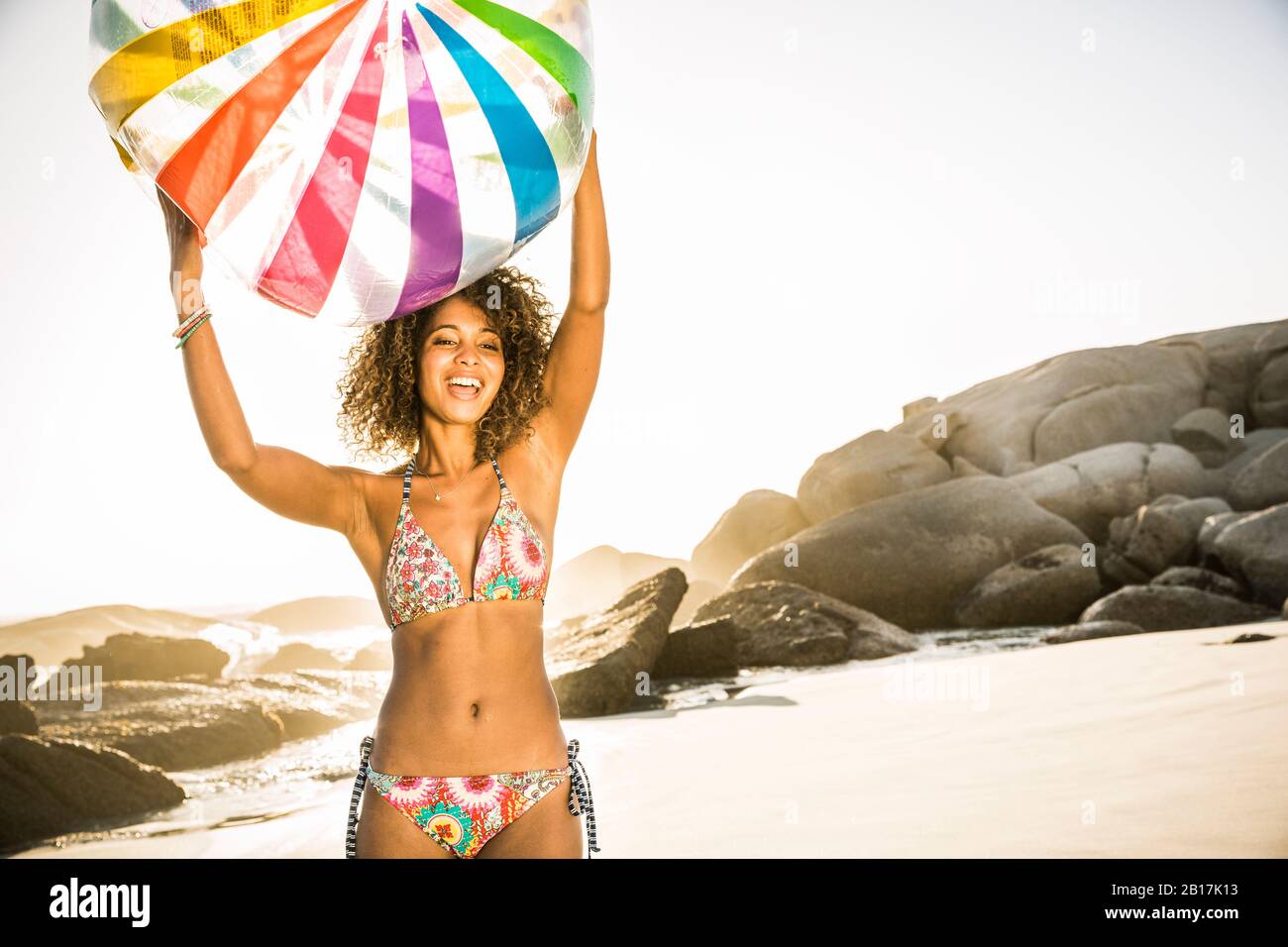 Young woman holding beach ball hi-res stock photography and images - Alamy