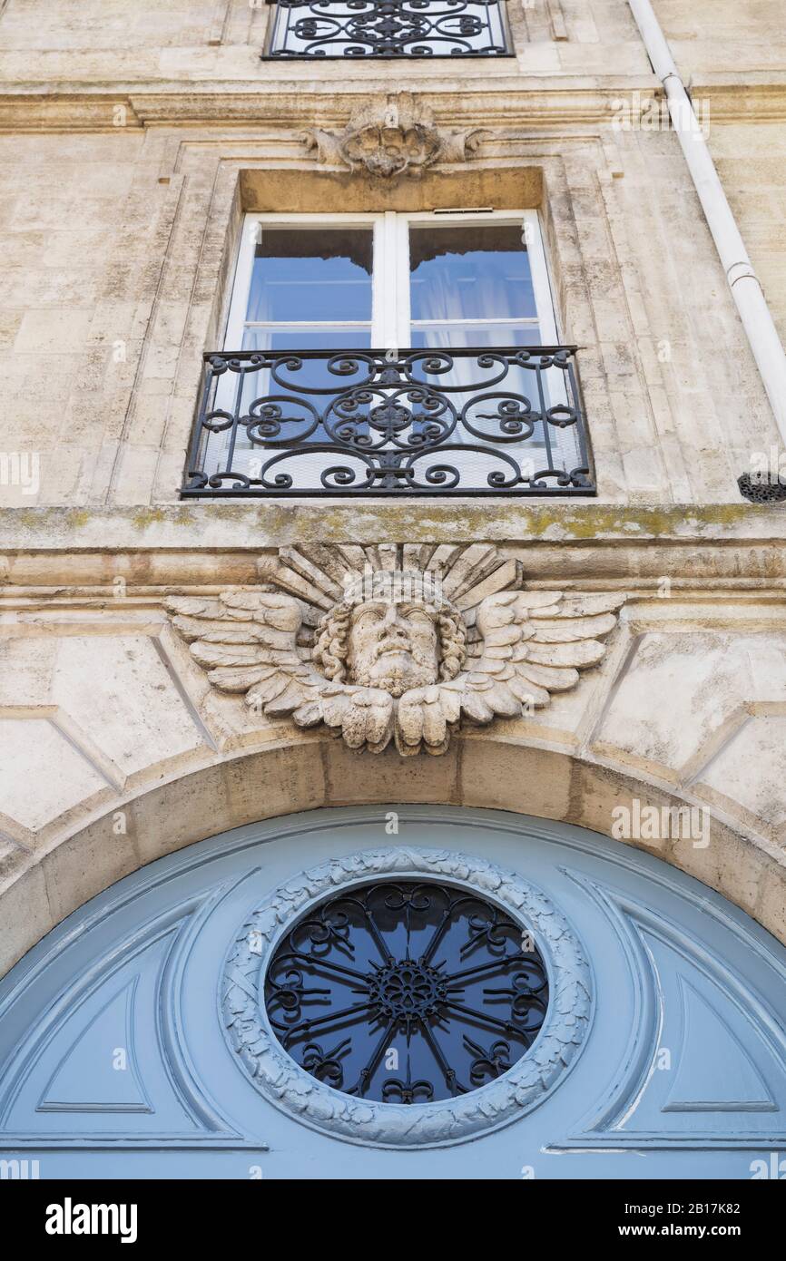 France, Gironde, Bordeaux, Low angle view of mascaron decorating entrance of residential building Stock Photo
