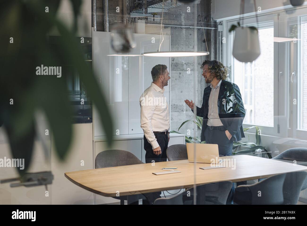 Two businessmen talking in office Stock Photo