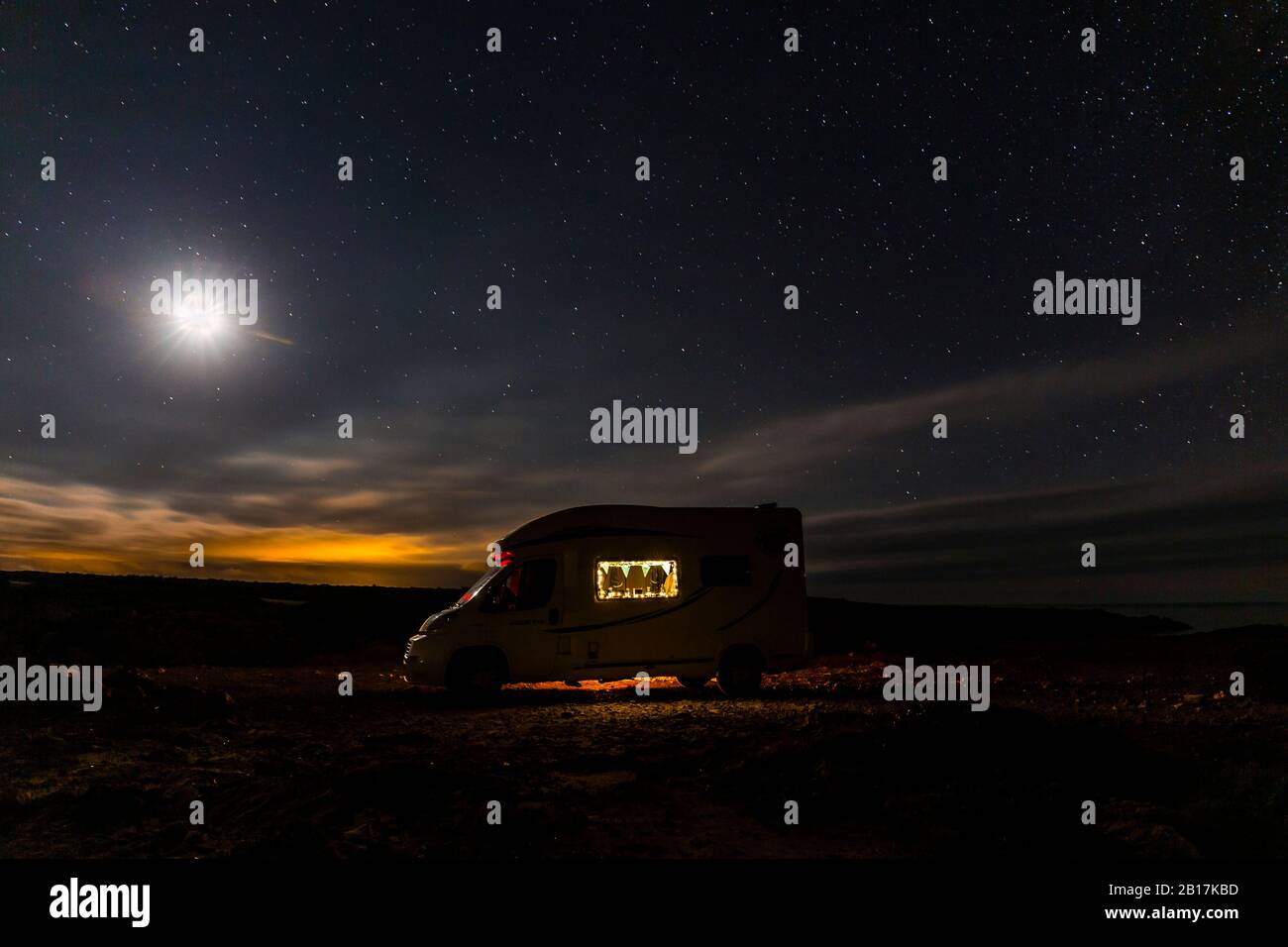 Lighted camper parking under starry skay, Es Mercadal, Menorca, Spain Stock Photo