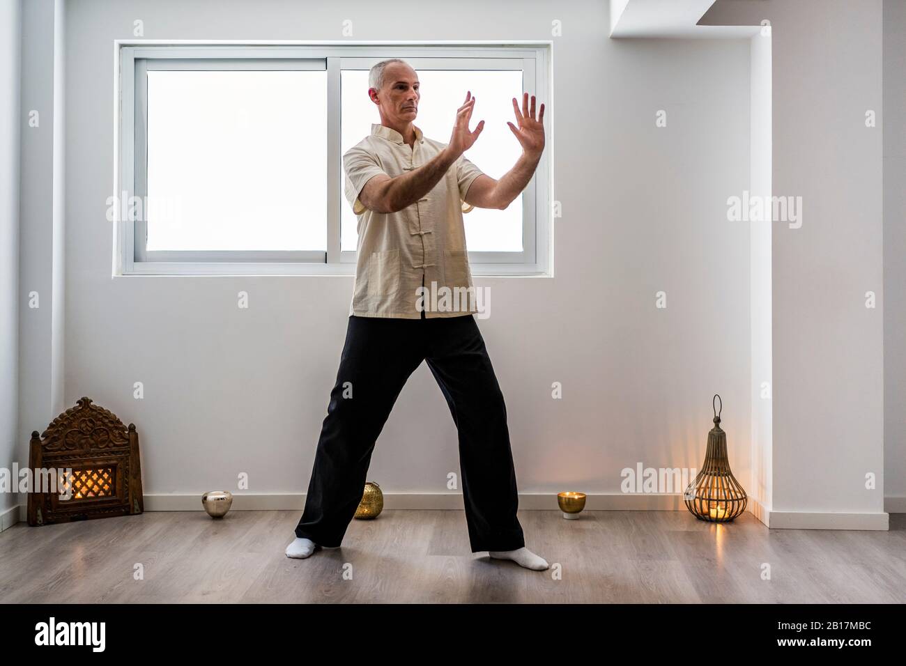 Man practicing martial arts in gym Stock Photo