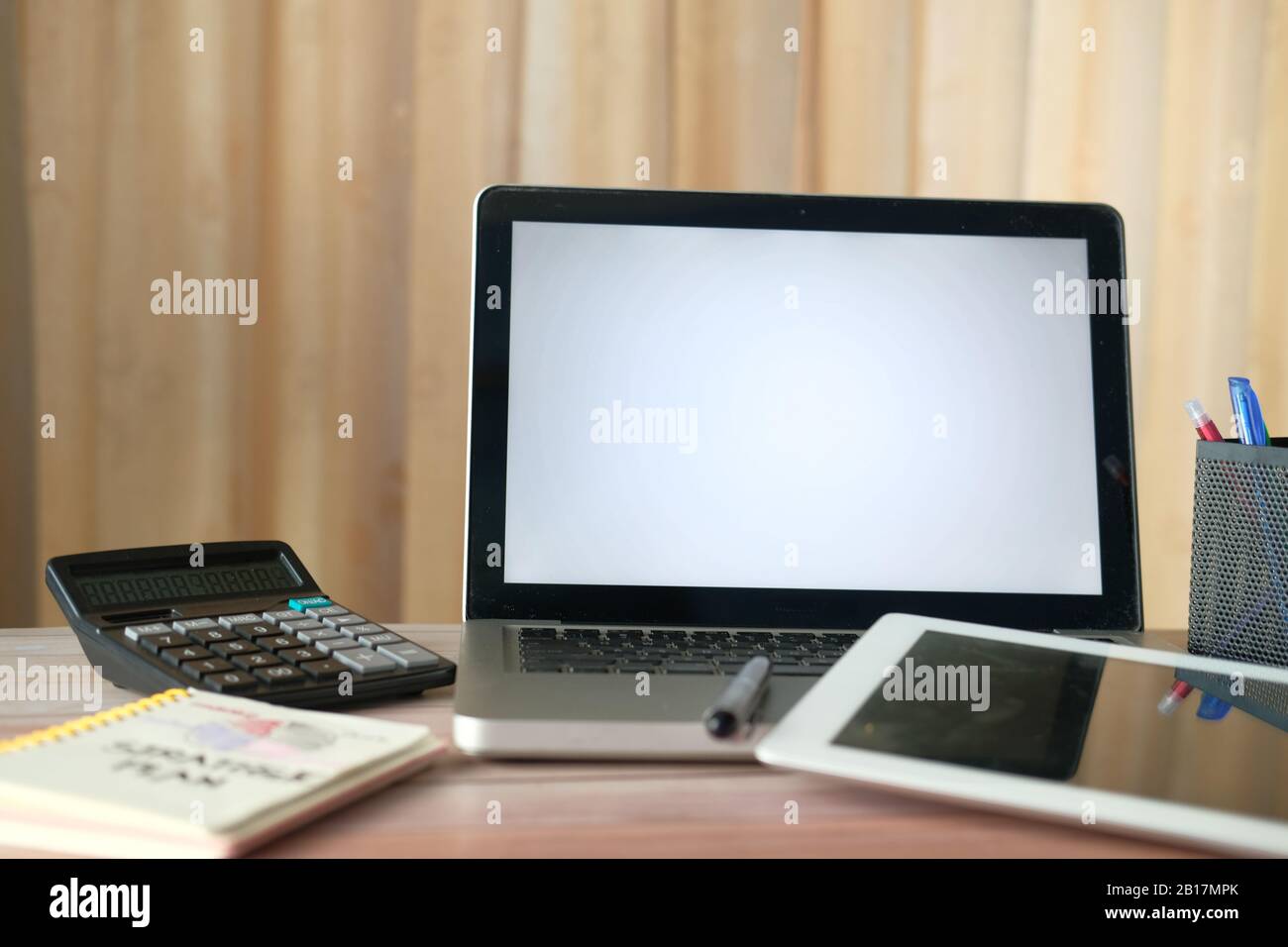 laptop, notepad and calculator on office desk  Stock Photo