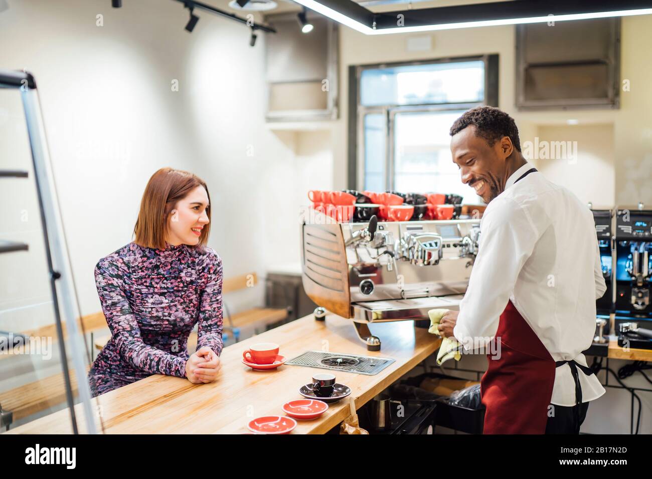 Woman at the counter in a cafe placing the order Stock Photo
