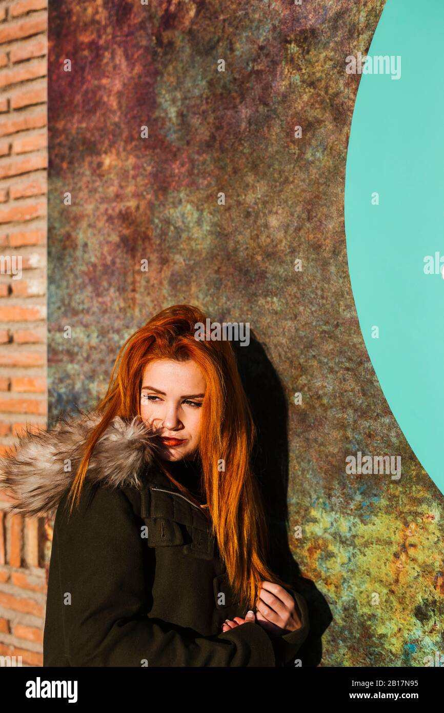 Portrait of redheaded young woman looking at distance Stock Photo - Alamy