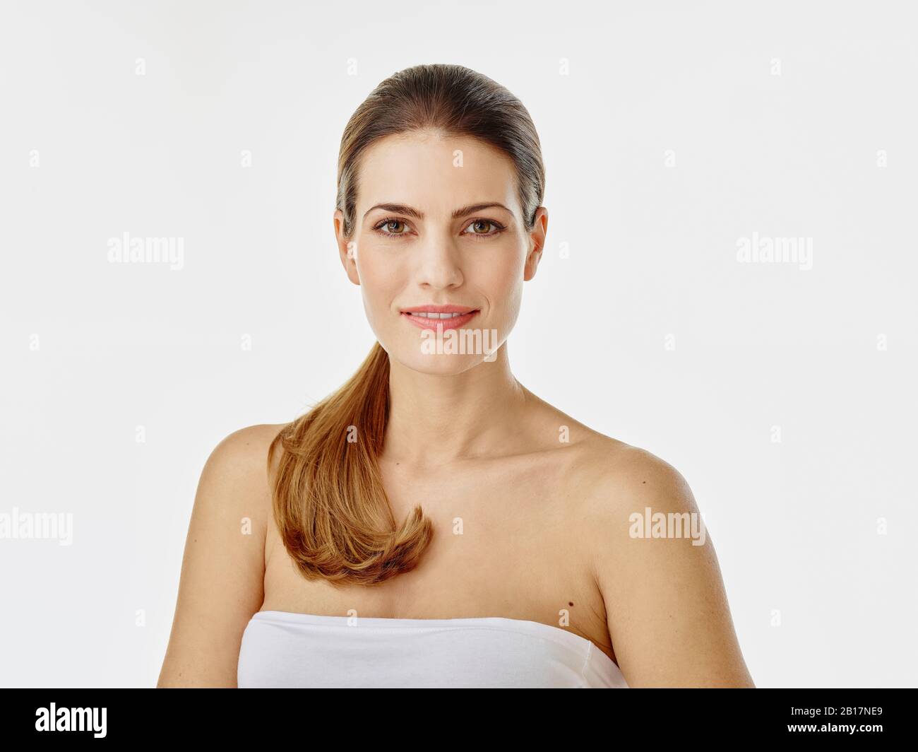 Portrait of smiling woman against white background Stock Photo - Alamy