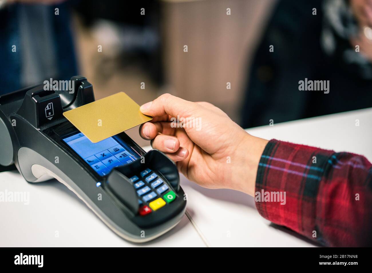 Close-up of man paying contactless with credit card Stock Photo