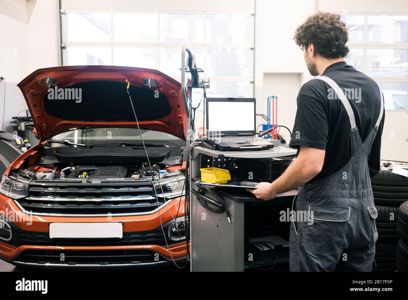 Car mechanic in a using modern diagnostic equipment Stock