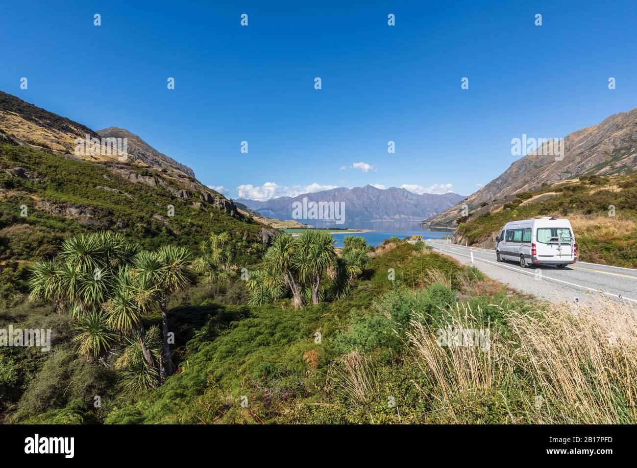 New Zealand, Queenstown-Lakes District, Wanaka, Camper van driving along road leading to Lake Hawea Stock Photo