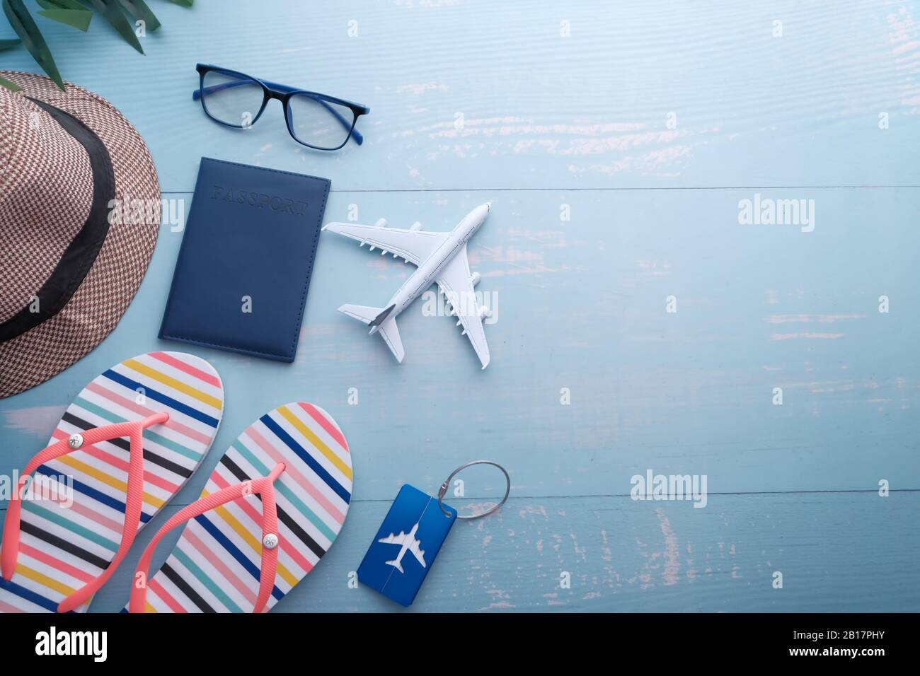 high angle view of tourist accessories on blue background ,hat 